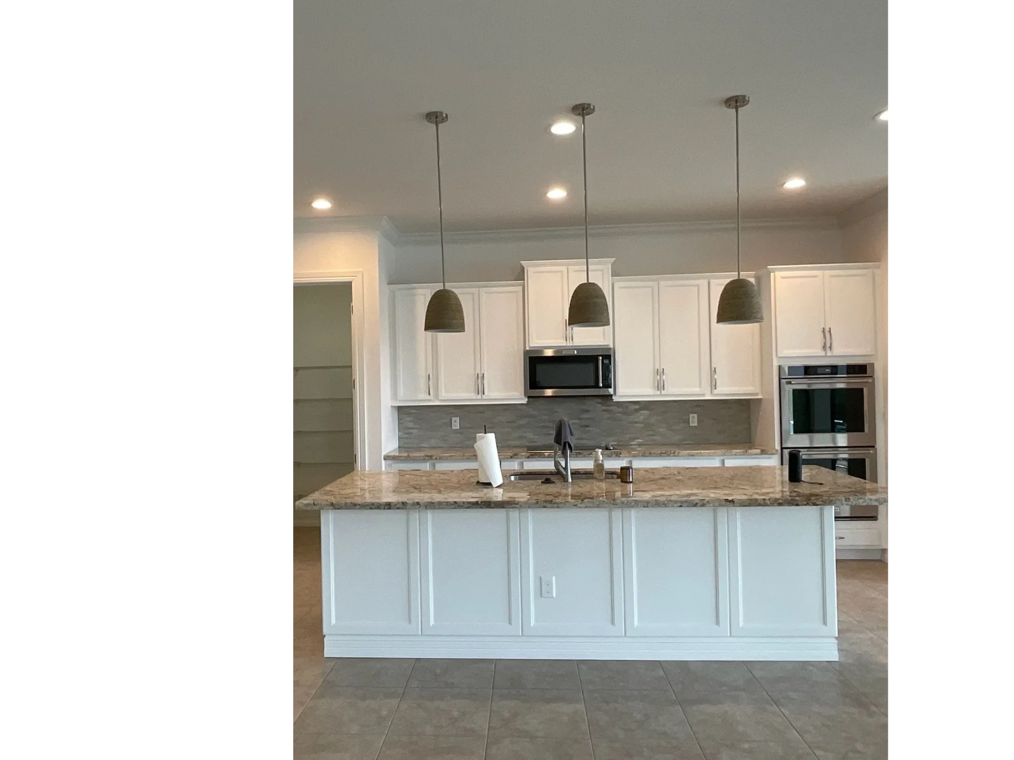 Professionally painted white kitchen cabinets by Paradise Painting Plus Inc in Southwest Florida