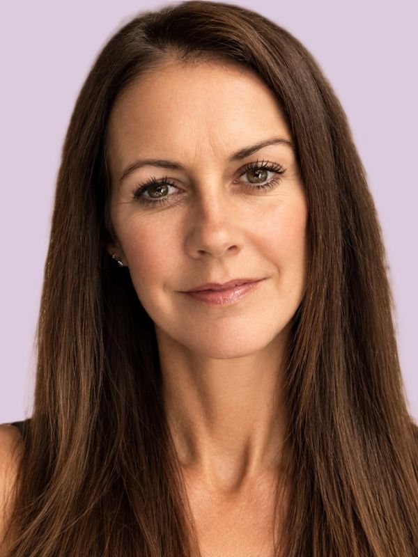 Portrait of a woman with long brown hair and a calm expression.