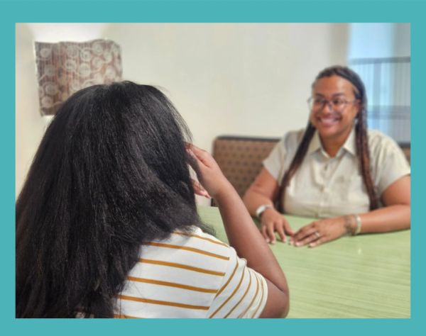 Two women engaged in a conversation at a table.
