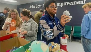 Community Youth excited about the gifts and engagement at Ashe Core 2025 Christmas Gifting Event.