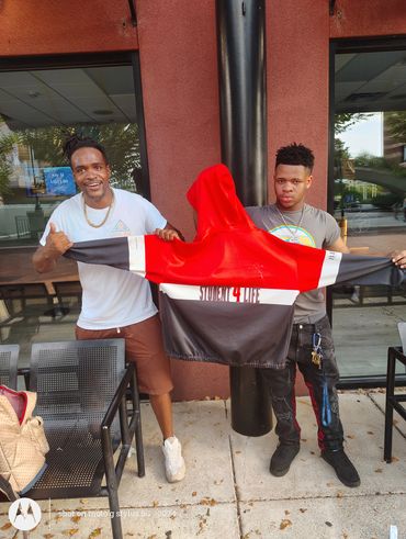 Ashe Core Youth with his Students For Life hoodie after an financial literacy education event.