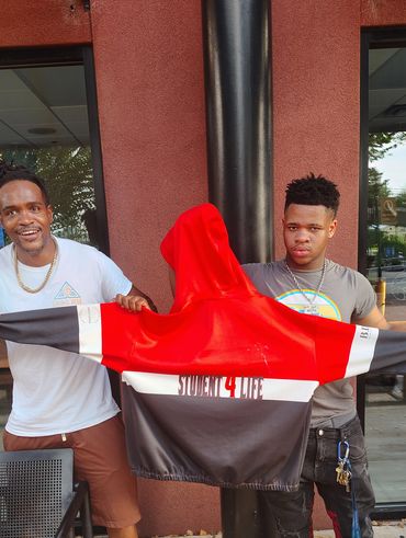 Student showing off his Students 4 Life hoodie. Ashe Core teaching youth empowerment.