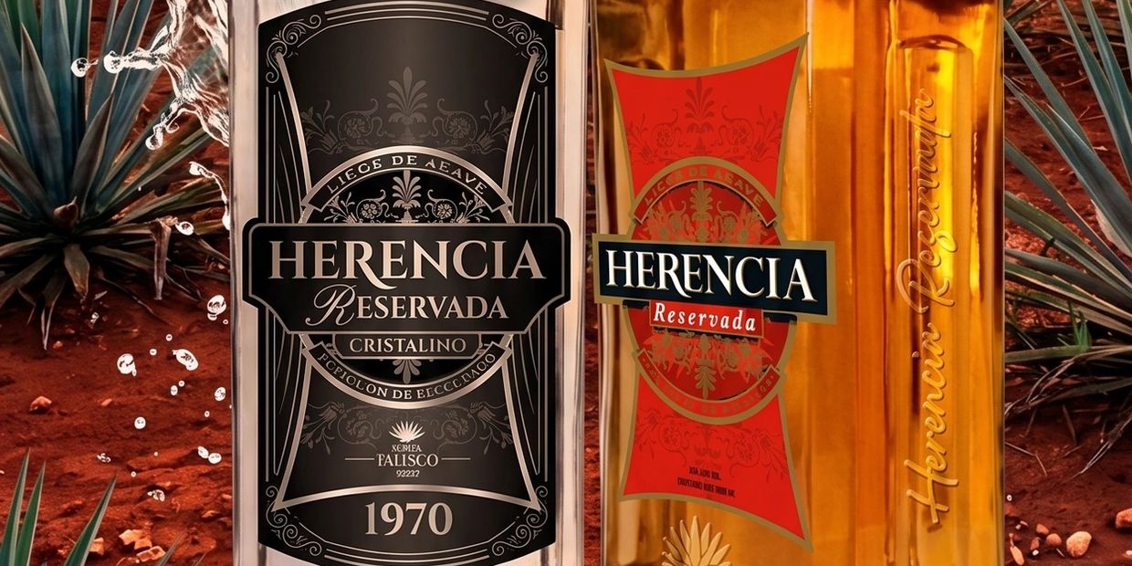 Two bottles of Herencia Reservada tequila with agave plants in the background.
