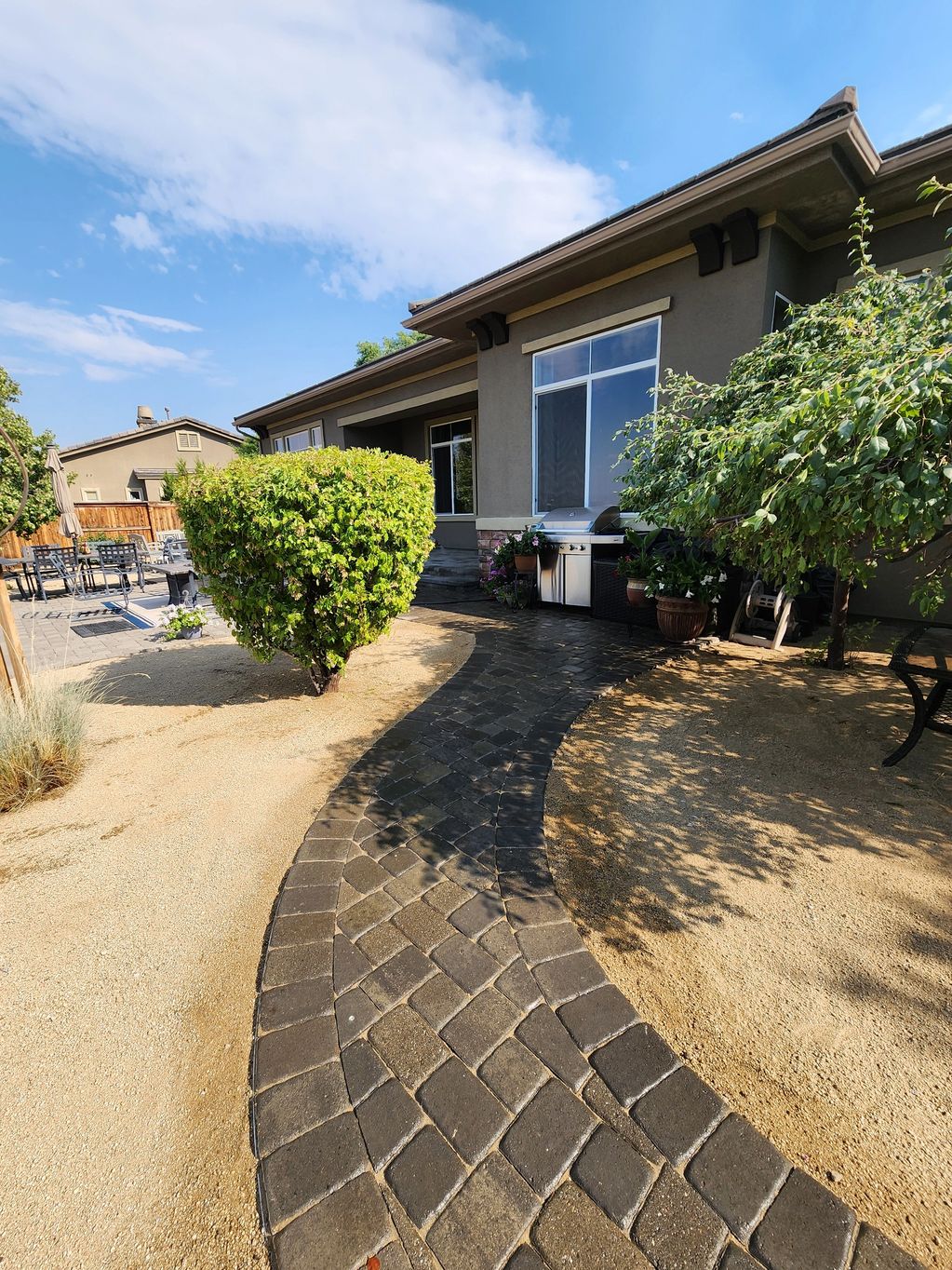 a Driveway and two trees surrounding it
