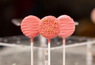 Three cake pops in a stand.