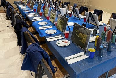 Table setting of a team building event where a mural is being created, piece by piece