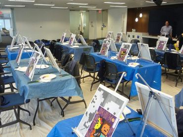 Portable art studio set-up in office with drop sheets on the floor