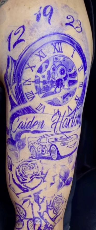 Tattoo stencil with clock, name, car, and roses on arm.