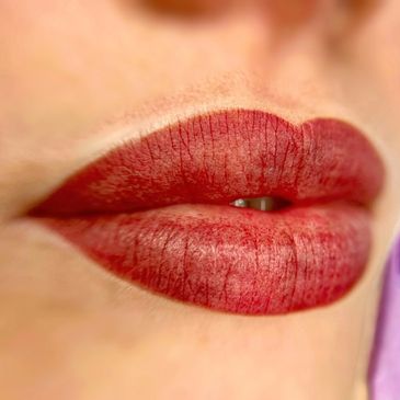 Close-up of red lipstick on lips.