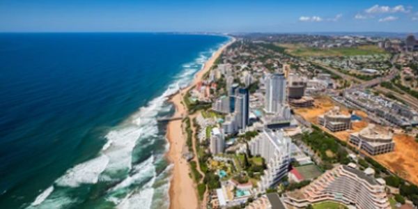 Aerial view of a coastal city with tall buildings along the beach.