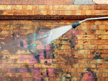 Graffiti removal using pressure washing