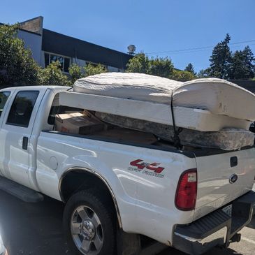 Mattresses tied down in back of truck