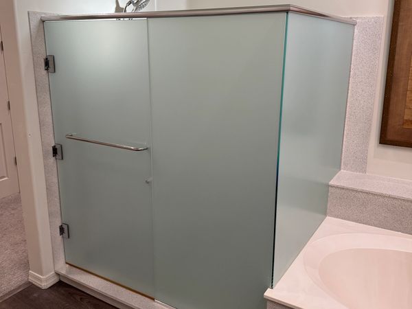 Frosted glass shower enclosure in a modern bathroom.