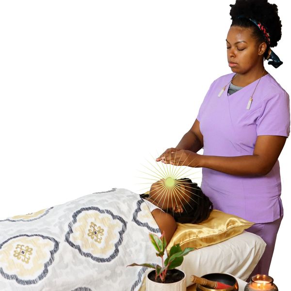 Therapist performing energy healing on a patient.