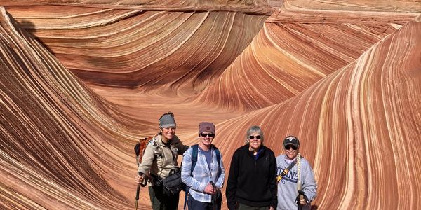 Group of four people standing at The Wave, AZ on private Lake Powell Scenic Tours guided tour