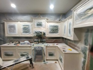 Kitchen cabinets covered for painting or renovation.