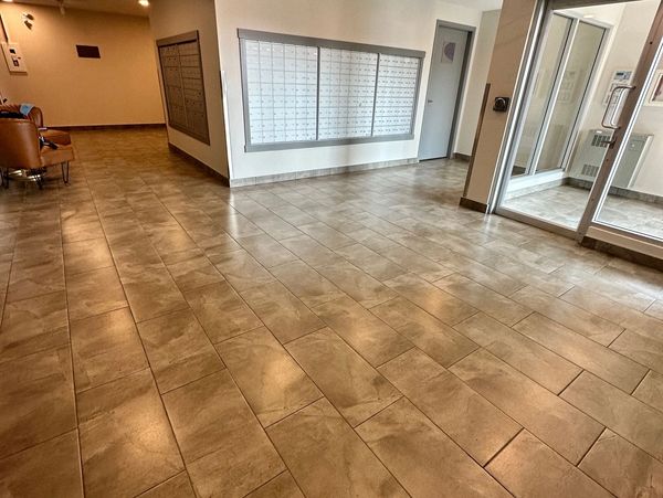 Apartment lobby with mailboxes and seating area.