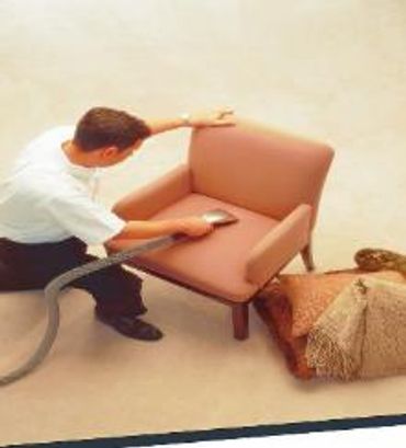 A man cleaning the chair of a house with machines
