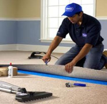 A man fixing the cutting mat on the floor