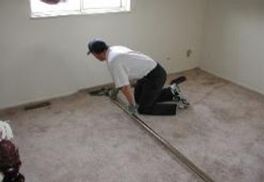 A man cleaning the floor of a house