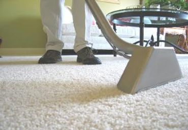 A man cleaning the mat of white color