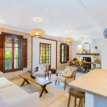 Bright, cozy living room with natural wood accents and woven light fixtures.