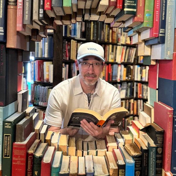 Aaron Reno is surrounded by books at The Last Bookstore in Los Angeles California.