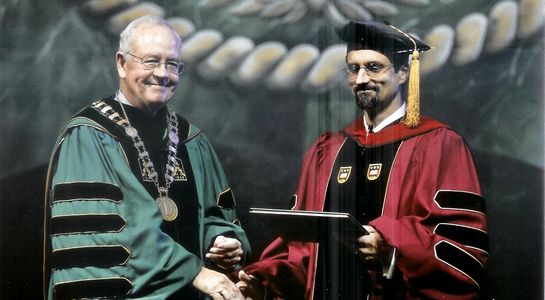 Baylor President Ken Starr presents Mike Foley an award for outstanding teaching in 2010.