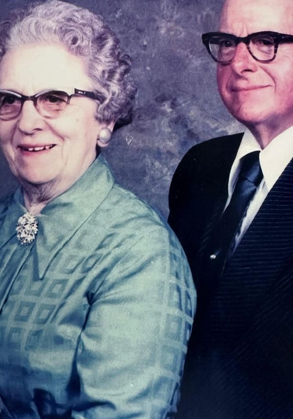Portrait of an elderly couple wearing glasses.