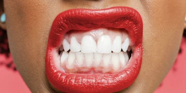  woman with red lipstick grinding white teeth