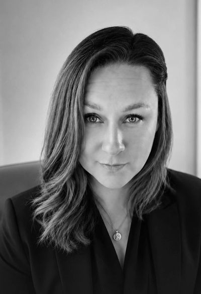 Black and white portrait of a serious woman with long hair.