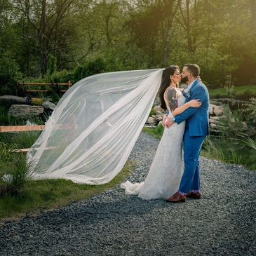 One of our couples kissing by our pond located in Middletown NY.