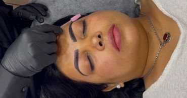 Woman getting eyebrow grooming with a brush.