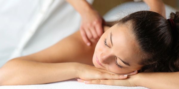 A woman is enjoying relaxing massage.