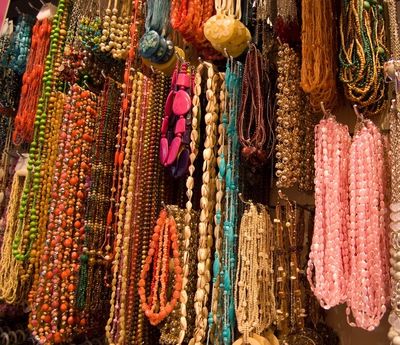 Huge wall of handmade artisan gemstone necklaces. Learn how to care for your J'tara jewelry here.