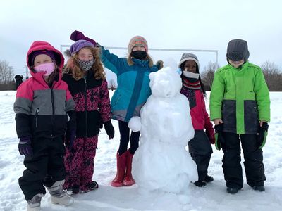 Kids building a snowman at Zen After School Program