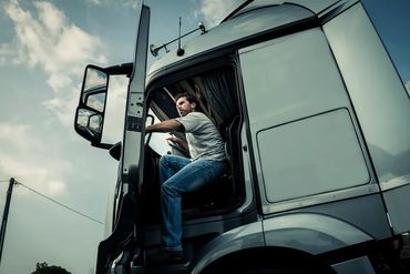 person getting into tractor trailer to go to work