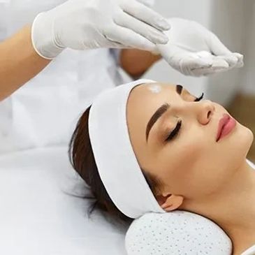 woman receiving dermatology facial