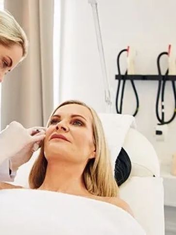 dermatologist applying Botox injection on woman