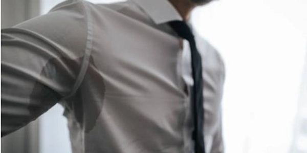 business man sweating because of hyperhidrosis