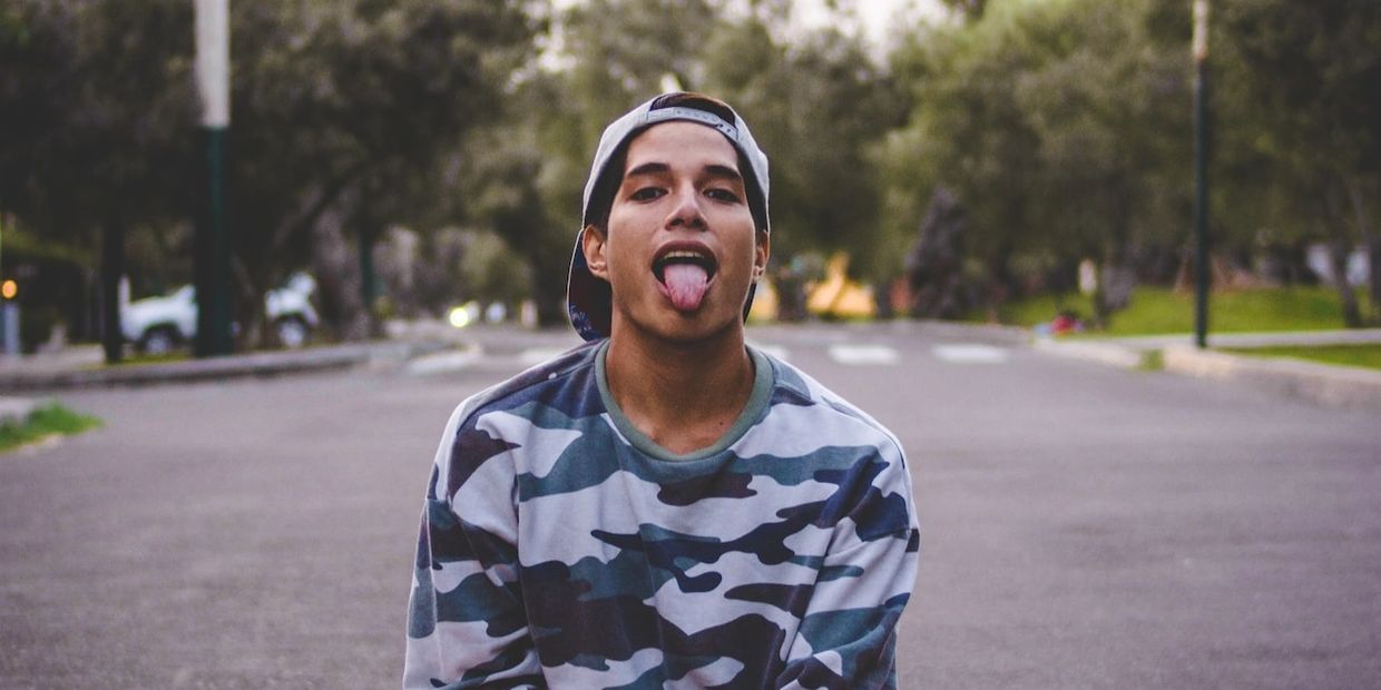 young man sticking a clean tongue out