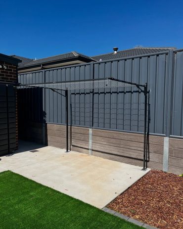 clothesline infront of colorbond fence on top of concrete sleepers