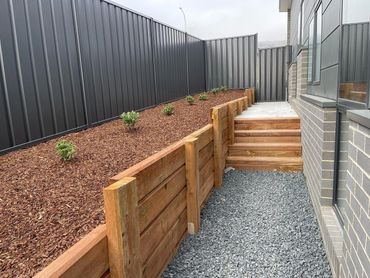 Colorbond fence and timber retaining wall with steps