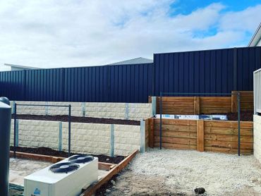 colorbond fence with concrete and timber retaining walls