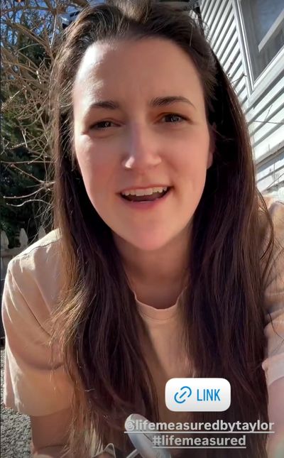 Young woman smiling outdoors with social media tags.