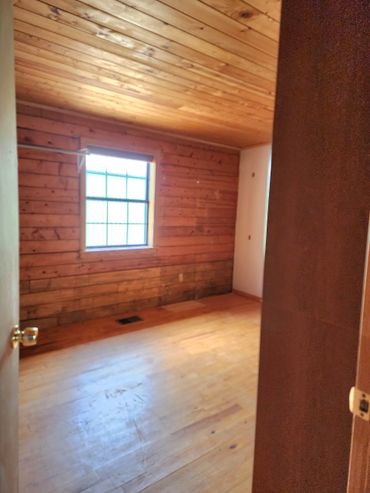 Modern bedroom renovation with renovated hardwood floors and fresh paint