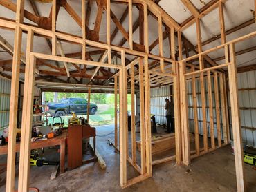 Spacious garage converted into a family entertainment room and functional office.