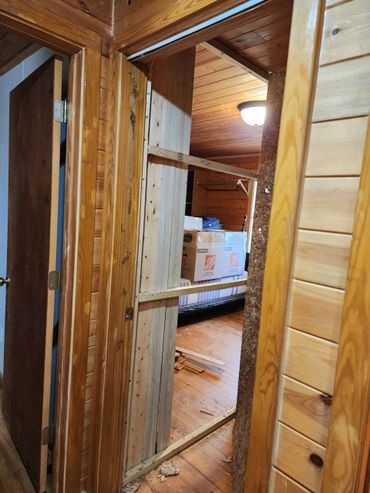 Modern bedroom renovation with renovated hardwood floors and fresh paint and wall removal.