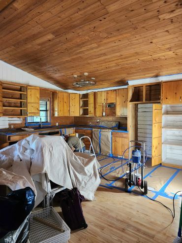 Kitchen renovation featuring sanded cabinets, new hinges, and updated hardware to save on costs.