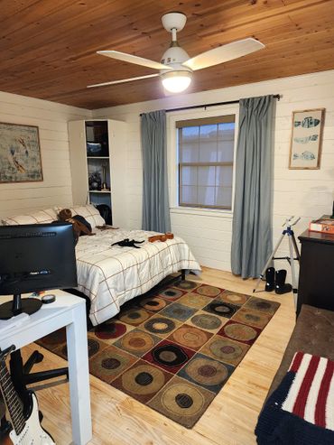 Renovated bedroom with contemporary design, neutral tones, updated lighting and updated furnishings.